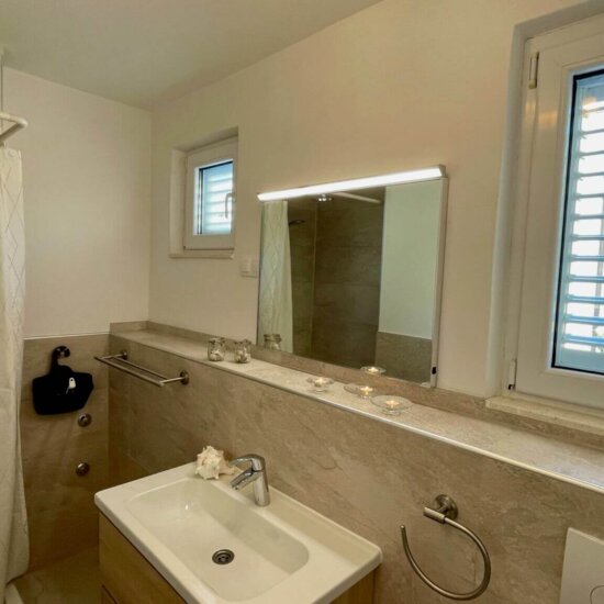 Modern bathroom with shower and sink.