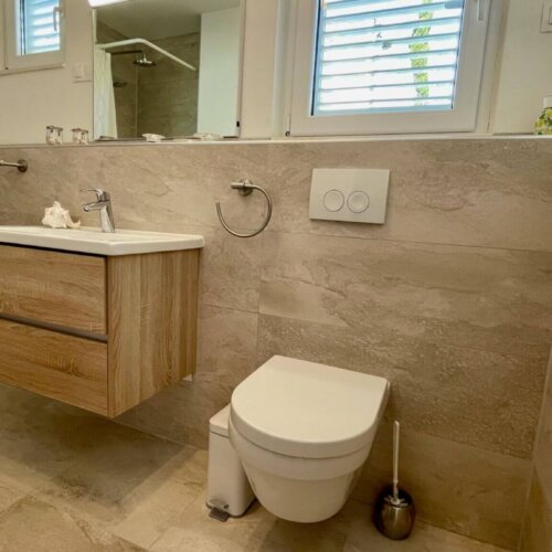 Modern bathroom with wooden accents.